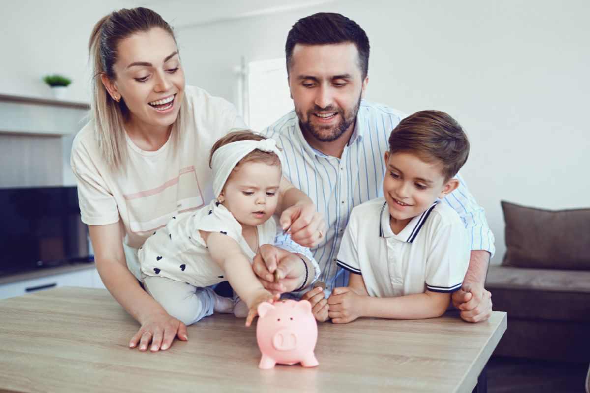 famiglia che mette dei soldi in un salavdanaio